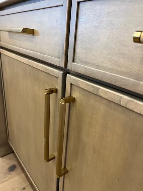 Close view of Timberland Flat Iron wood finish and brass cabinet hardware