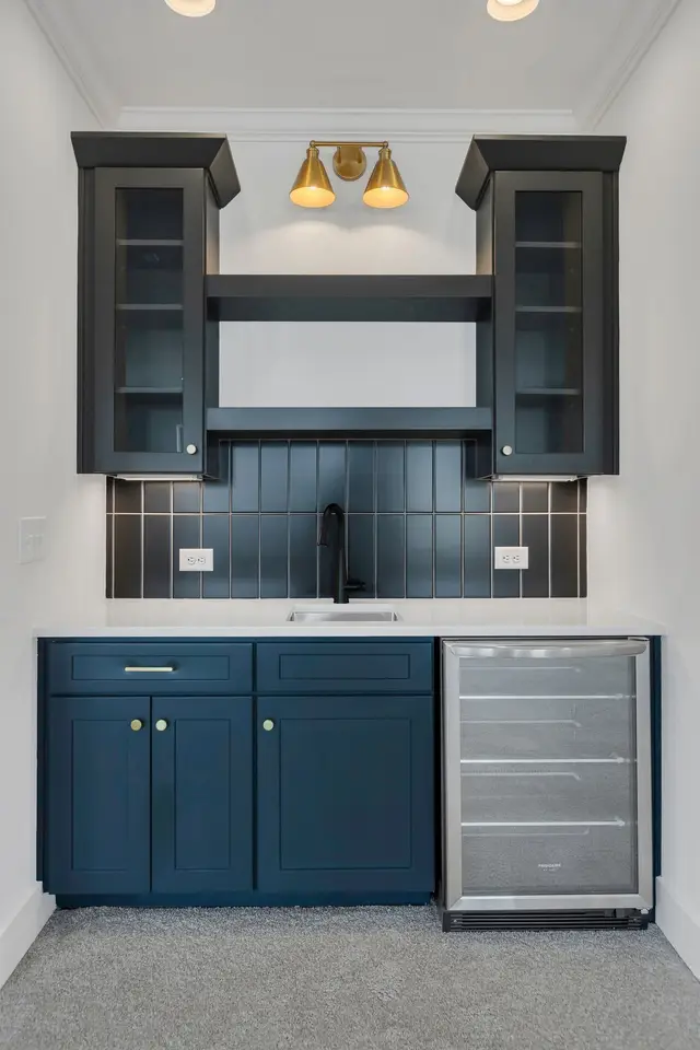 Naval wet bar with glass uppers and a beverage fridge
