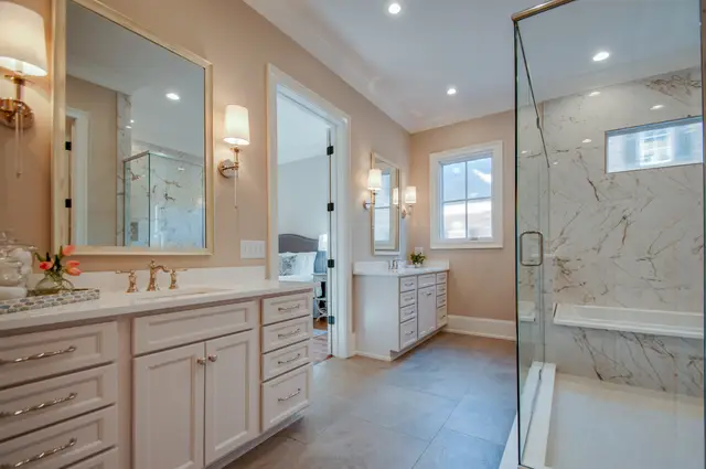 Oyster vanity with a marble shower beyond