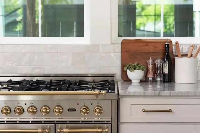 Range wall with brass hardware and marble counters