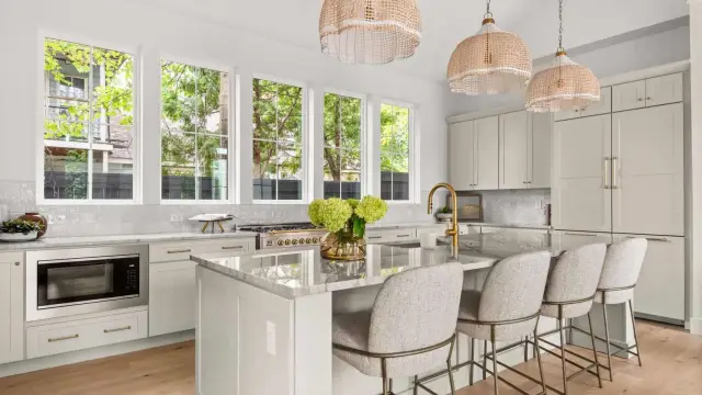 Oyster island with counter seating and rattan pendants