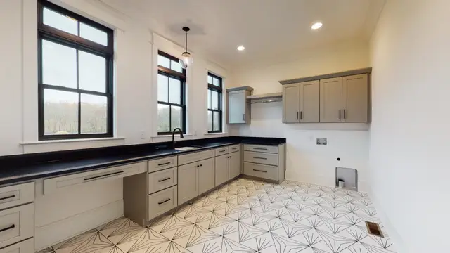 Pearl laundry cabinetry with a folding counter