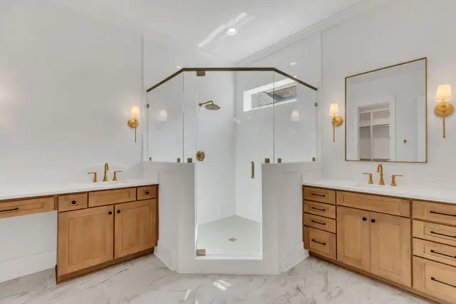 Twin Sand vanities flanking a corner shower