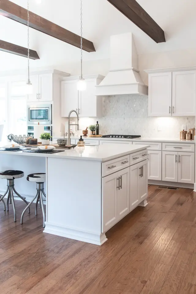 Timberland White kitchen with a plaster hood and exposed beam