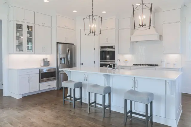 Timberland White kitchen with glass uppers and lantern pendants
