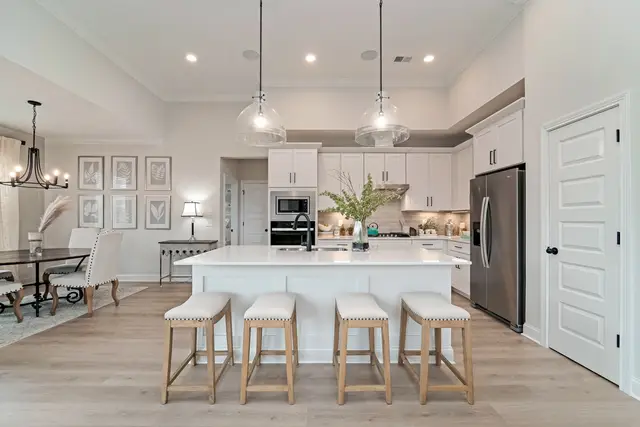 Timberland White kitchen with island seating and a built-in desk