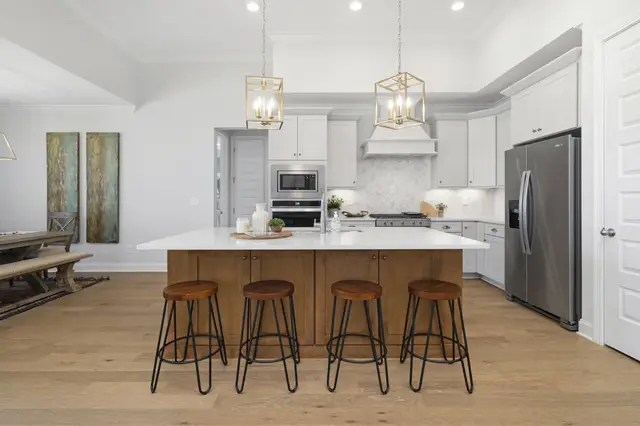 Timberland White perimeter cabinetry with a Sand island